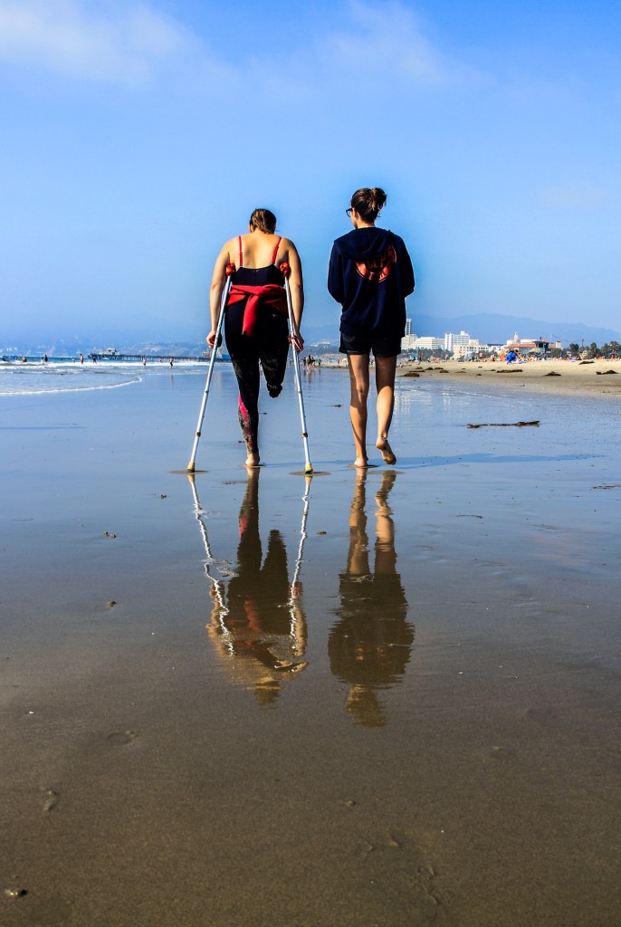 Sisters Lyndsay and Emily Lucas walk down the beach together. Photo: Monica Salazar