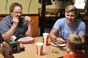 Mike Ignelzi, owner of Rib Ranch, a family own restaurant, enjoys BBQ Ribs with family Jamie White,3,  and and Danny White ,25, on October 4, 2014 in Woodland Hills Calif.