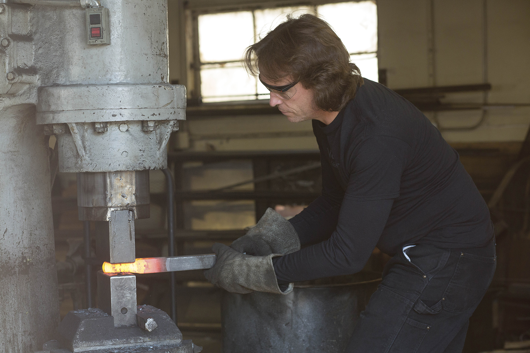 Phillip Bowling shapes a heated piece of iron for a pierce that he is designed for a client Nobel Forge wearhouse in North Hollywood, Calif. on March 22, 2016. (photo by joshua duarte)