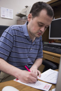 Matt Thacker, instructional assistant for the Media Arts dept., working at his desk on Nov. 15, 2016, in the Village at Pierce College, Woodland Hills, Calif. Photo by Amy Au