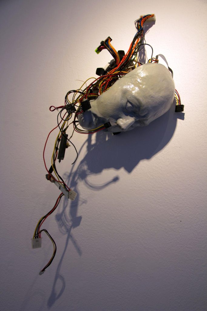 It Speaks for Itself, is a plaster mask with wires by Naomi Nadreau, at the CSUN Shed gallery. Photo by Alan Castro.